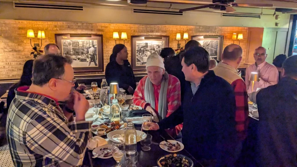 Last Boston WordPress meetup event of the year. Photo of attendees chatting and networking