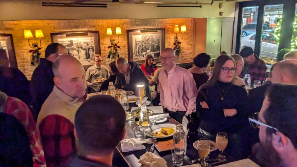 Last Boston WordPress meetup event of the year. Photo of attendees chatting and networking